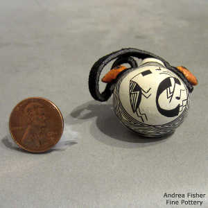 Black and white kokopelli and geometric design on a miniature polychrome canteen with animal head handles