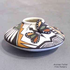 Butterfly, shard and geometric design on a miniature polychrome jar
