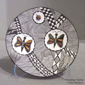 Lady bug, butterfly, fine line and geometric design on a polychrome plate