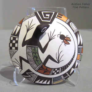 Lizard, lady bug and geometric design on a polychhrome seed pot