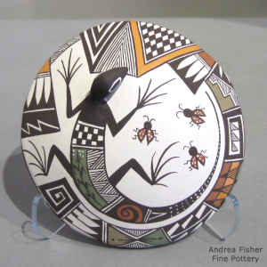 Lizard, lady bug and geometric design on a polychrome seed pot