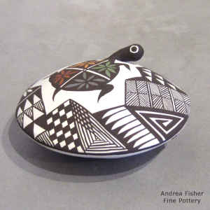 Turtle and geometric design on a polychrome seed pot