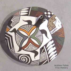 A turtle and geometric design on a polychrome seed pot