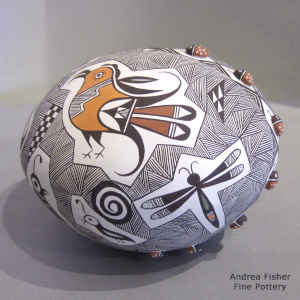 Mimbres animals, parrot, lady bugs and fine line geometric design on a polychrome seed pot