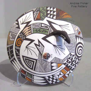 Lizard, lady bug and geometric design on a polychrome seed pot