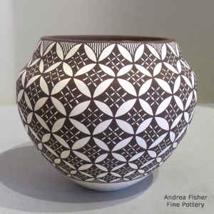 A snowflake geometric design on a black and white jar