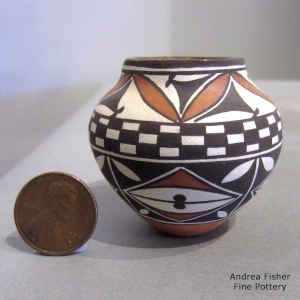 Checkerboard and 4-panel geometric design on a miniature polychrome jar
