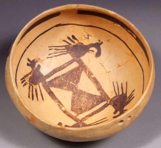 Yellow bowl with black bird element and geometric design on the inside