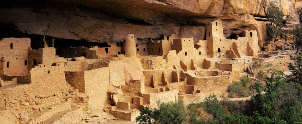 A view of Cliff Palace, a large stacked stone architecture structure of maybe 150 rooms built under a rock overhang at Mesa Verde National Park