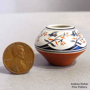 Polychrome miniature jar with a bird, branch and geometric design