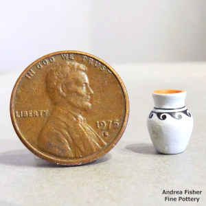 Polychrome miniature jar with a band of geometric design
