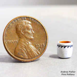 Polychrome miniature jar with a band of geometric design