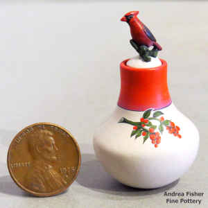 Polychrome miniature jar with a chokecherry branch design and a red cardinal lid