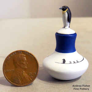Polychrome miniature jar with a penguin and geometric design and a penguin lid