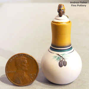 Polychrome miniature jar with a pine cone design and a chipmunk munching on a pine cone on the lid