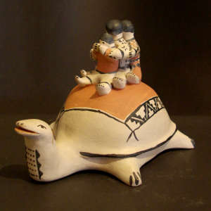 Three children on a turtle storyteller