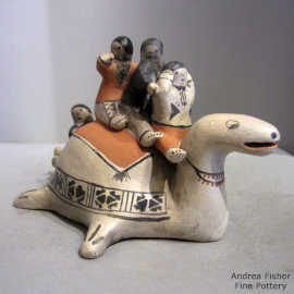 4 children riding on the back of a turtle