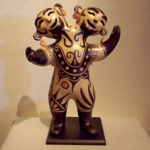 Geometric design on a polychrome two-headed circus figure