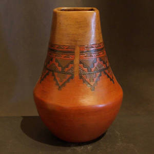 Band of Dineh rug design around the neck of a square mouthed brown jar