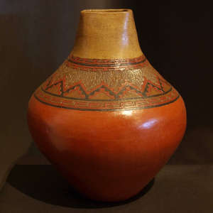 Band of Dineh carpet design around the neck of a polychrome jar with a square opening