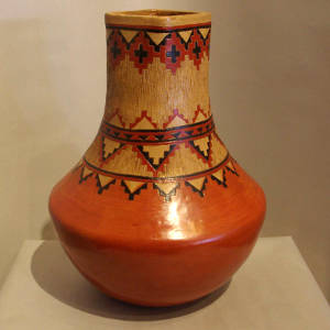 Band of Dineh rug design around the neck of a brown jar