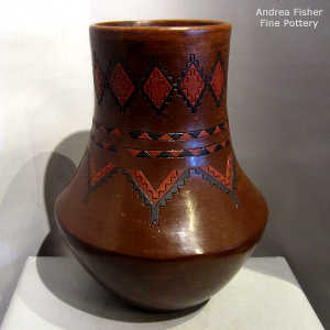 Dineh carpet design and pine pitch coating on a tall neck jar