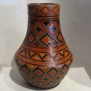 Dineh rug design and poine pitch coating on a large tall neck brown jar