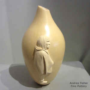 Carved applique of a Hopi man on a tan vase