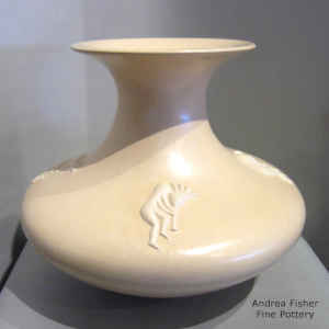 Four kokopelli appliques on a buff-colored jar with a rolled top