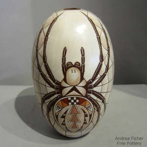 Click for a larger version A spider and geometric design on a polychrome seedpot