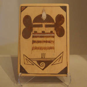 Katsina design on a black on buff tile