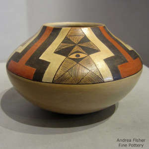 Black and red fine line and geometric design on a yellow ware jar