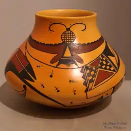 Moth, bird element and shard design on a polychrome yellowware jar