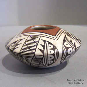 Stylized bat wing migration pattern design on a polychrome jar