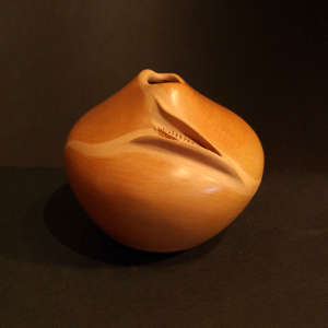 Raised ear of corn on a brown jar