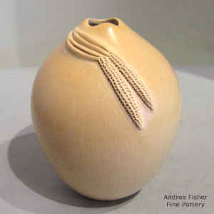 Ear of corn applique on a tan seed pot with an organic opening