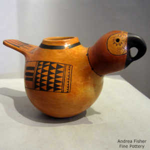 Geometric wing design in black on a red bird effigy pot