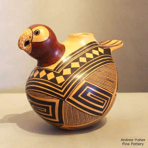Black and red geometric design on a yellow ware bird effigy pot