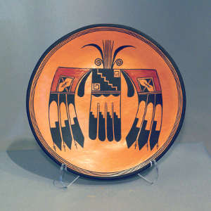 Thunderbird design in the bottom of a shallow yellow ware bowl