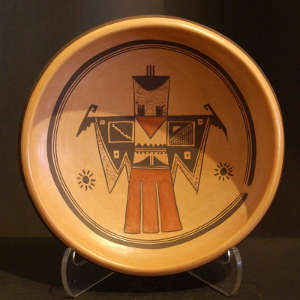 Stylized thunderbird design inside a low polychrome bowl