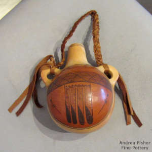 Eagle tail, dragonfly and geometric design on a polychrome canteen