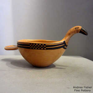 Black bird element and geometric design on a yellow ware bird effigy ladle