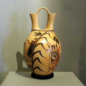 Red, black and orange corn maiden, bird and eagletail design on a yellow ware wedding vase