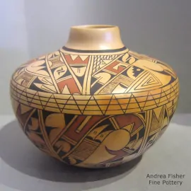 Polychrome yellowware jar with a shard, bird element and geometric design in black and red
