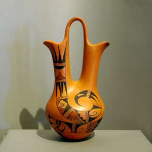 Red and black rainbird design on a yellowware wedding vase