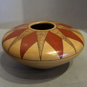 Red and brown sunburst pattern on a polychrome seedpot