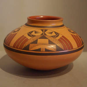 Four direction bird element and geometric design on a tan Sikyatki-style jar