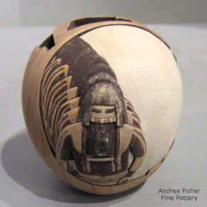 Carved, painted and sgraffito dancer, geometric design and pueblo background on a polychrome seed pot