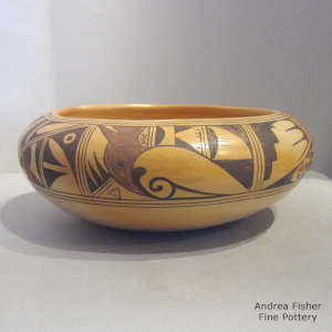 Bird element and geometric design decorate a polychrome yellowware bowl