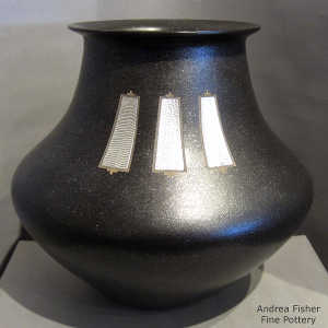 3 inlaid Shifting Sands silver pieces on a black micaceous jar